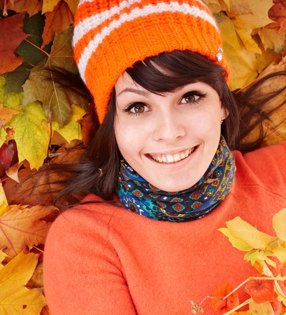 Young woman in autumn orange leaves. Outdoor.の写真素材