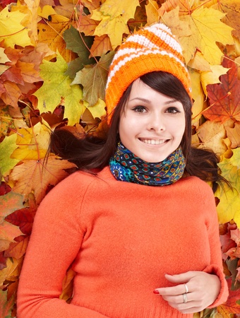 Young woman in autumn orange leaves. Outdoor.の写真素材