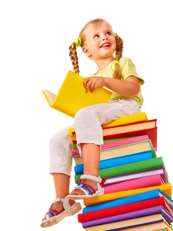 Little girl sitting on stack of books. Isolated.の写真素材