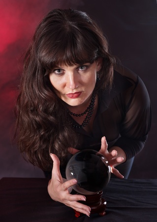 Young woman  with crystal ball. Beauty and fashion.の写真素材
