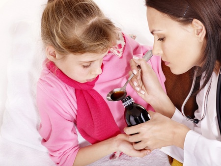 Sick child take  medicine with doctor. Isolated.の写真素材