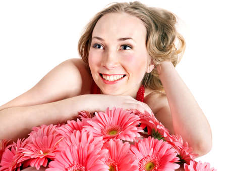 Happy young woman lying on flowers.の写真素材
