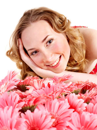 Happy young woman lying on flowers.の写真素材