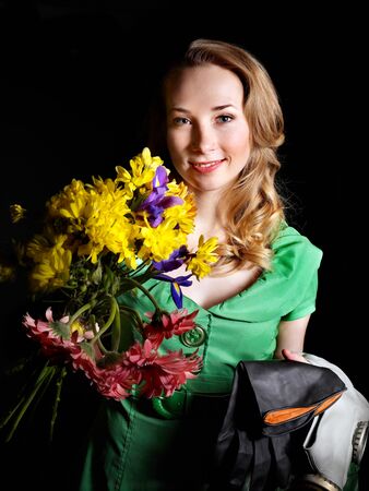 Young woman holding flowers and gas mask .の写真素材
