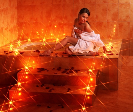 Woman sitting on edge of bath tub.の写真素材