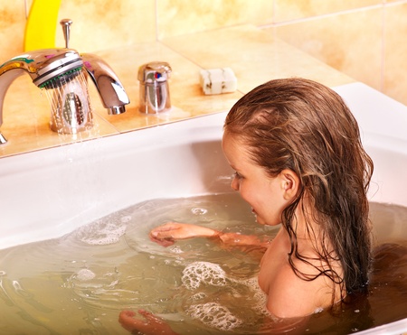 Child washing in bubble bath .の写真素材