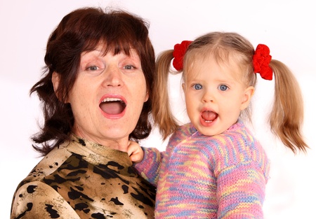 Portrait of grandmother and granddaughter. White background.の写真素材