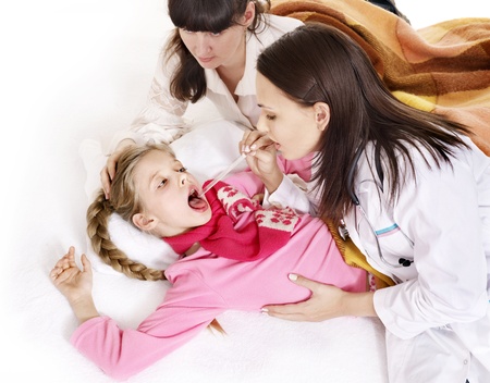Doctor examining child with sore throat. Isolated.の写真素材