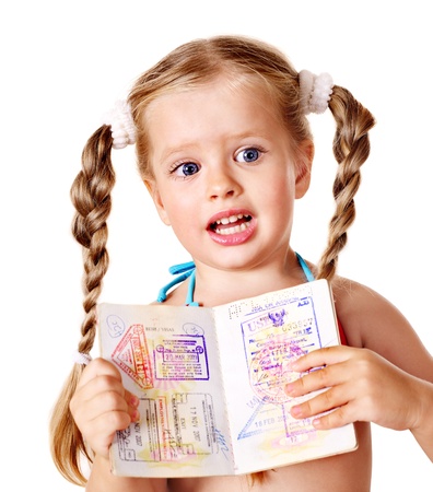 Little girl  holding international passport. Foreign vacation.の写真素材