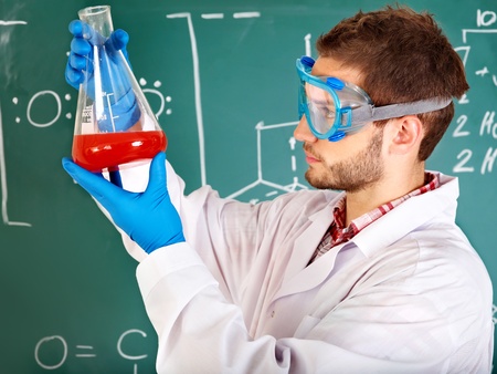 Man chemistry student with flask in classroom.の写真素材