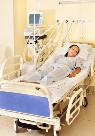 Sick patient on gurney in operating room.の写真素材