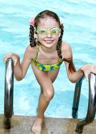 Little girl swim  in swimming pool.の写真素材