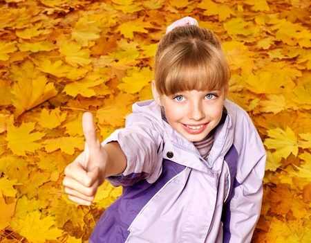 Child in autumn orange leaves. Outdoor.の写真素材