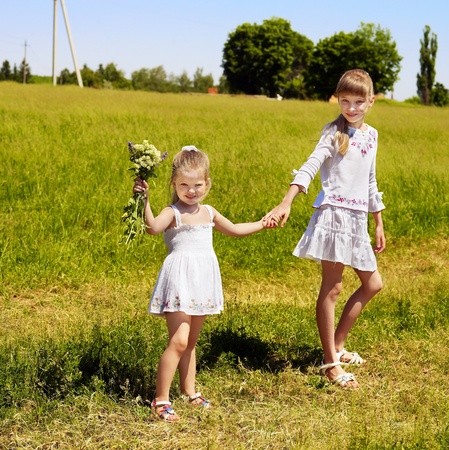 Group children running across green grass outdoor. の写真素材
