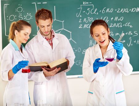 Group chemistry student with flask in classroom.の写真素材