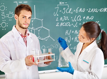 Group chemistry student with flask in classroom.の写真素材