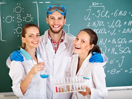 Group chemistry student with flask in classroom.の写真素材