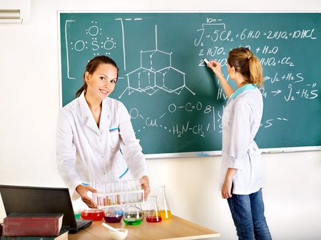 Female chemistry student with flask in classroom.の写真素材