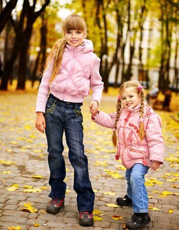 Child in autumn orange leaves. Outdoor.の写真素材