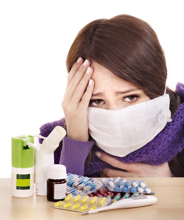 Young woman having flu takes pills.の写真素材