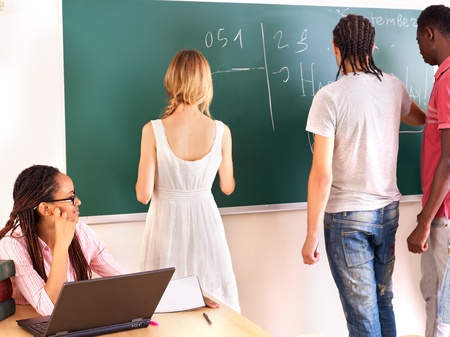 Group student in classroom near blackboard.の写真素材