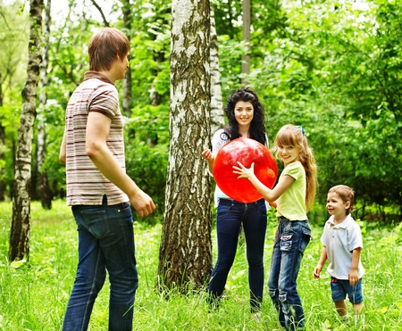 Outdoor happy family with children playing ball .の写真素材