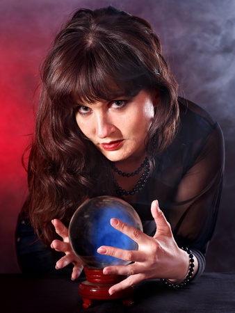 Young woman  with crystal ball. Fortune telling.の写真素材
