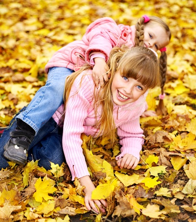 Child in autumn orange leaves. Outdoor.の写真素材