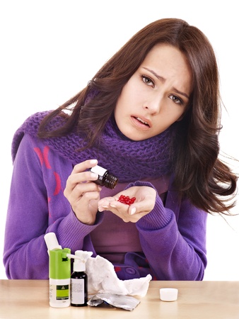 Young woman having flu takes pills.の写真素材