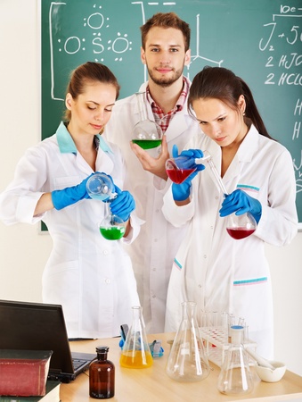 Group chemistry student with flask in classroom.の写真素材