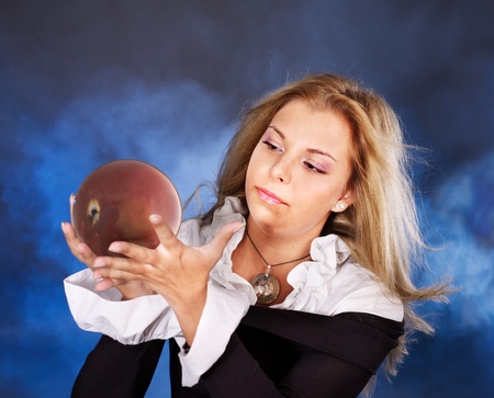 Young beautiful woman with crystal ball.の写真素材