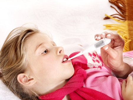 Doctor checking temperature of child.の写真素材