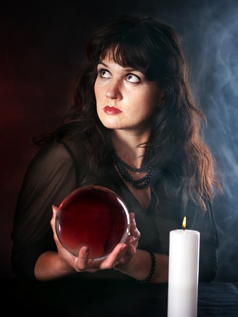 Young woman  with crystal ball. Beauty and fashion.の写真素材