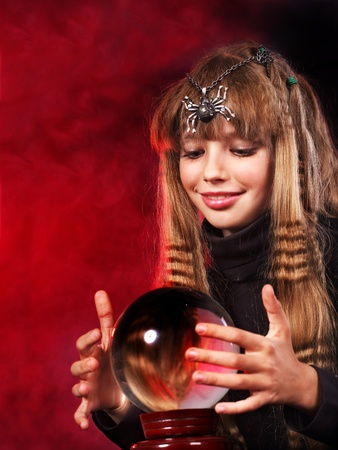 Little girl holding crystal ball. Fortune telling.の写真素材