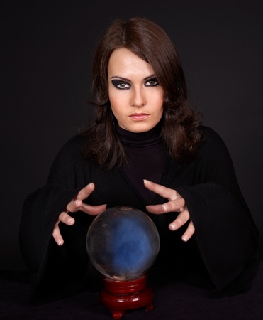 Young beautiful woman with crystal ball.の写真素材