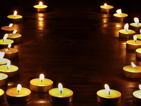 Group of burning candles on  black background.の写真素材