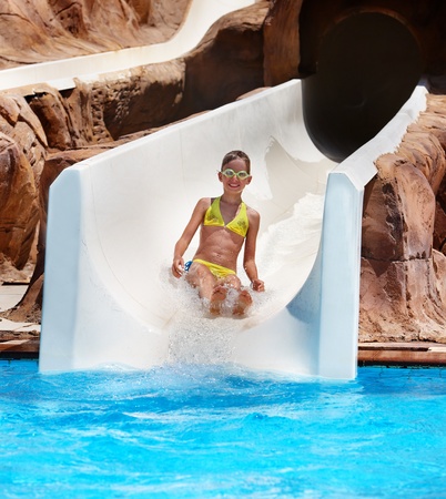 Child on water slide at aquapark. Summer holiday.の写真素材