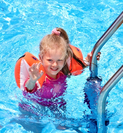 Child with armbands in swimming pool. Summer outdoor.の写真素材