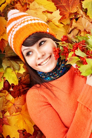 Young woman in autumn orange leaves. Outdoor.の写真素材