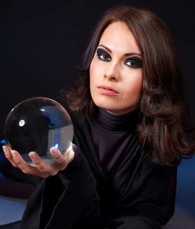 Young beautiful woman with crystal ball.の写真素材