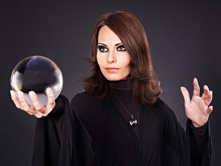 Young beautiful woman with crystal ball.の写真素材