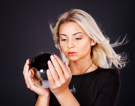 Young beautiful woman with crystal ball.の写真素材