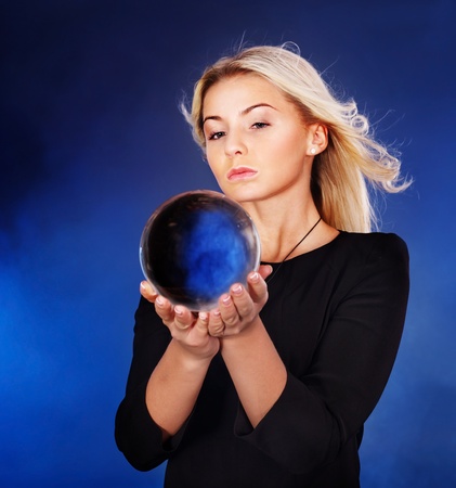 Young beautiful woman with crystal ball.の写真素材