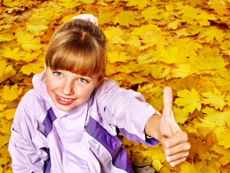 Child in autumn orange leaves. Outdoor.の写真素材