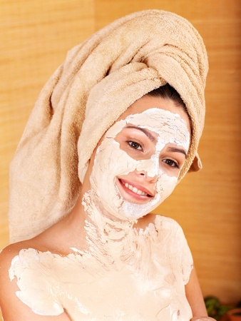 Beautiful girl having clay body mask apply by beautician.の写真素材
