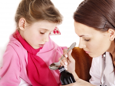 Sick child take  medicine with doctor. Isolated.の写真素材