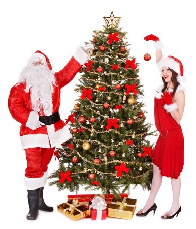 Santa claus and girl by christmas tree and gift box. Isolated.の写真素材