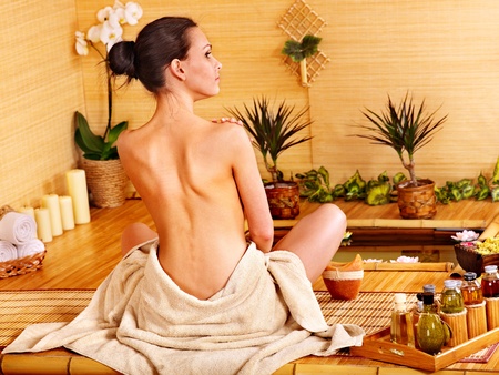 Bamboo massage at spa and woman.の写真素材