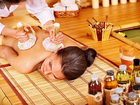 Young woman getting massage in bamboo spa.の写真素材