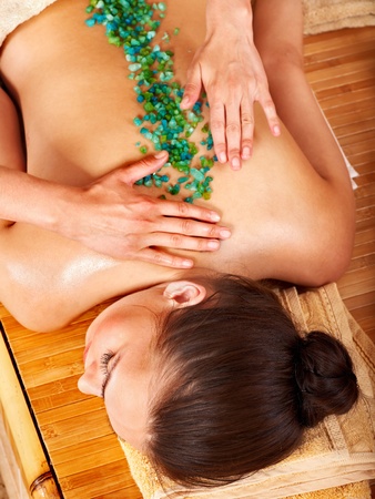 Young woman getting salt massage.の写真素材
